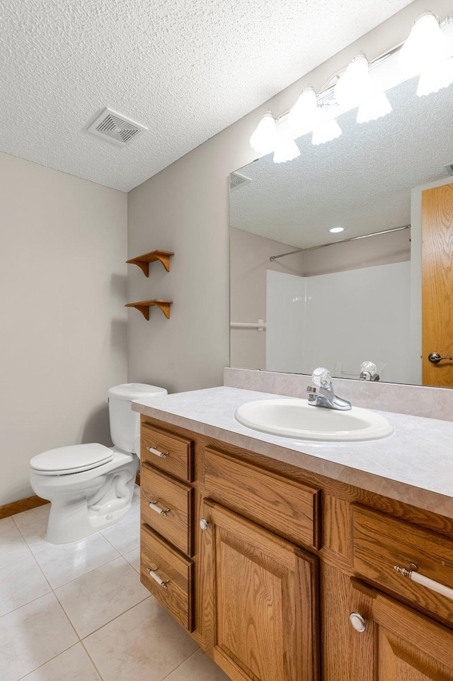 full bathroom featuring visible vents, toilet, a textured ceiling, vanity, and tile patterned flooring