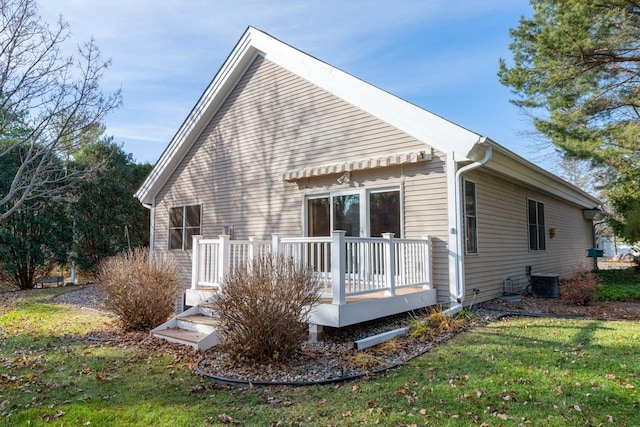 back of house featuring a yard and a wooden deck