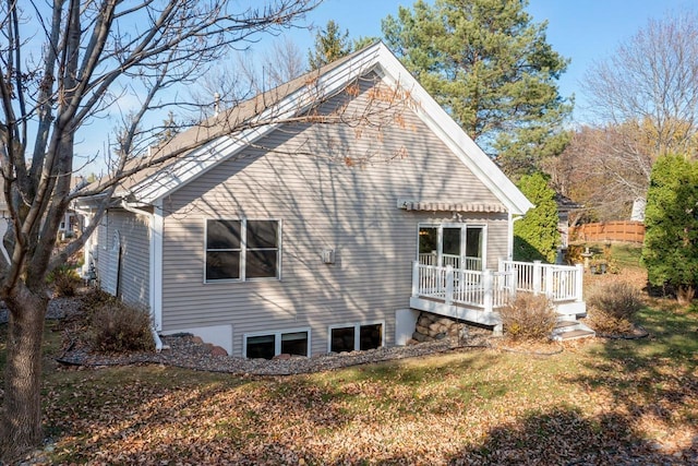 view of home's exterior featuring a deck and a lawn