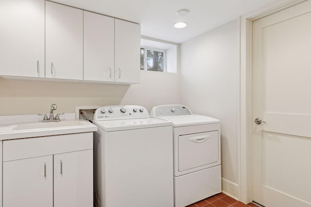 washroom with a sink, cabinet space, and washing machine and dryer