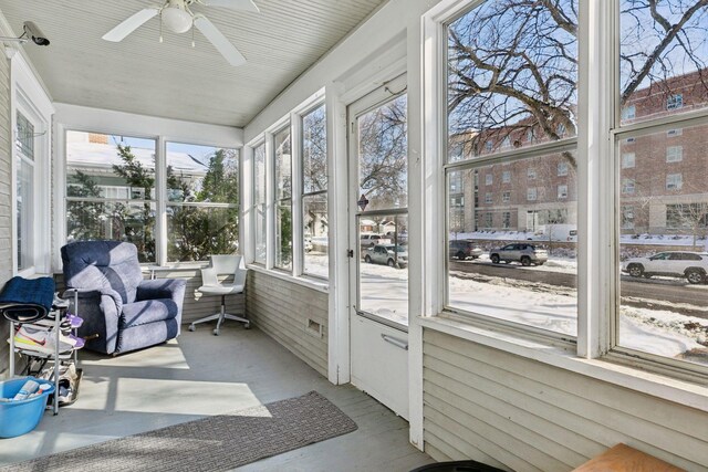 sunroom / solarium featuring plenty of natural light and ceiling fan