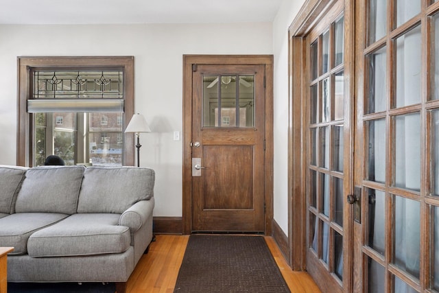 foyer featuring baseboards and wood finished floors