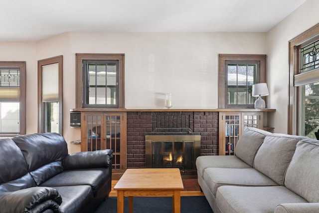 living room featuring a brick fireplace