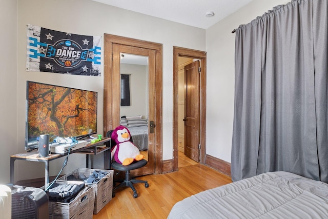 bedroom featuring wood finished floors and baseboards