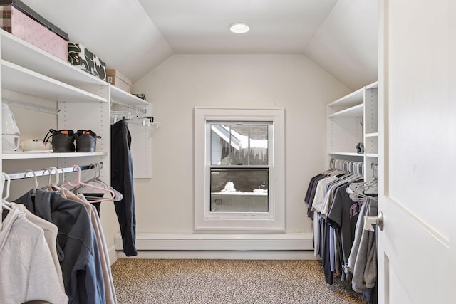 walk in closet with carpet floors and vaulted ceiling