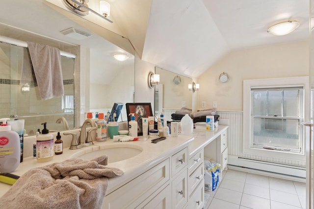 full bathroom with tile patterned flooring, visible vents, a baseboard heating unit, vaulted ceiling, and wainscoting