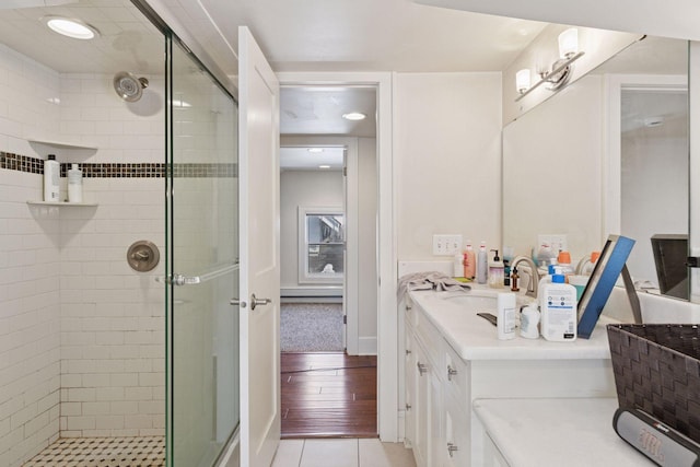 bathroom featuring a stall shower, vanity, and tile patterned flooring