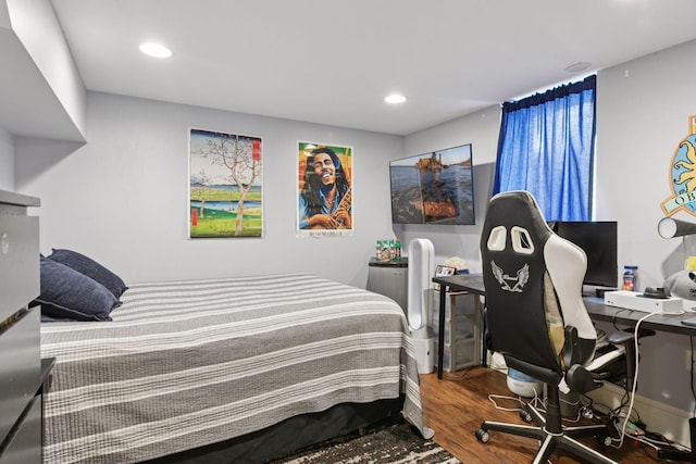 bedroom featuring recessed lighting and wood finished floors