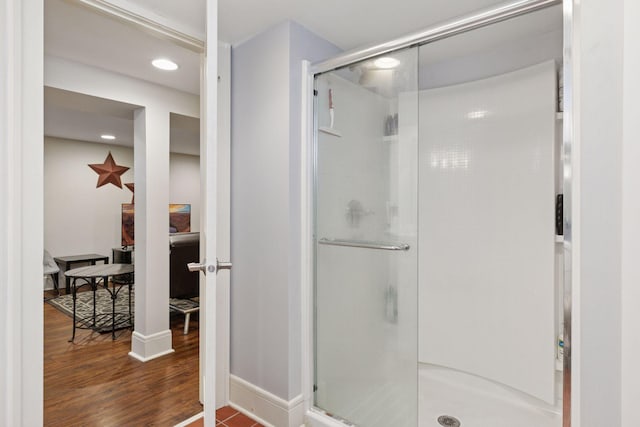 full bath with recessed lighting, a shower stall, baseboards, and wood finished floors