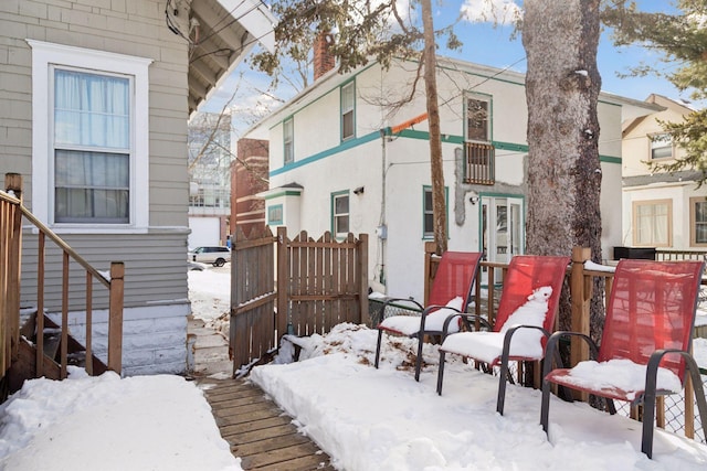 snow covered property featuring a chimney