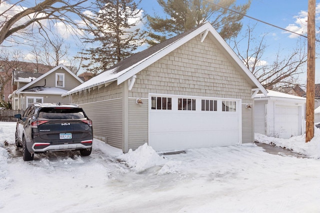 snow covered garage with a garage