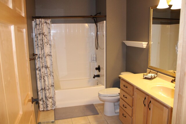 bathroom with tile patterned floors, vanity, toilet, and shower / bath combo with shower curtain