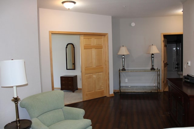 living area featuring wood finished floors and baseboards