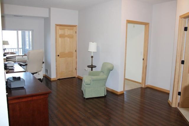 office with visible vents, baseboards, and dark wood-type flooring