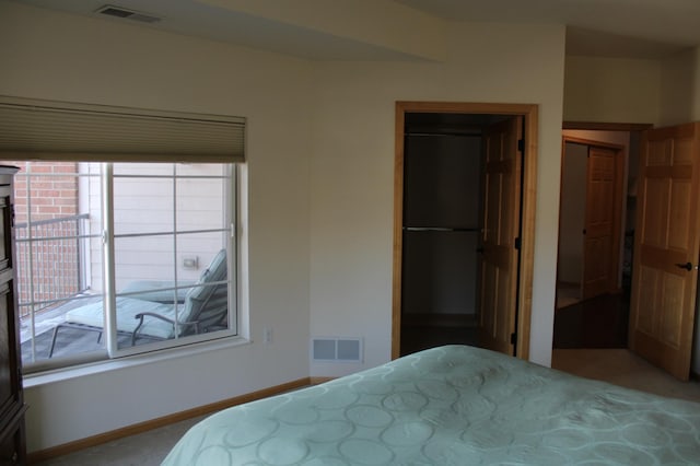 bedroom featuring a spacious closet, visible vents, a closet, and baseboards