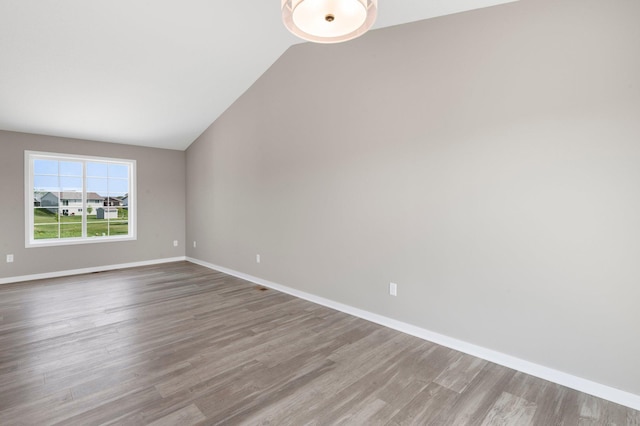 1001 Misty Meadow Blvd, Buffalo, MN 55313 - unfurnished room featuring wood finished floors, vaulted ceiling, and baseboards