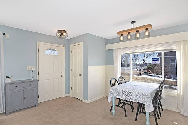 dining room with light carpet and baseboards