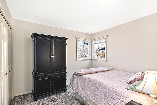 bedroom featuring a closet and baseboards