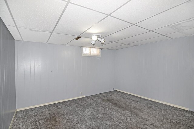 basement featuring carpet flooring and a drop ceiling