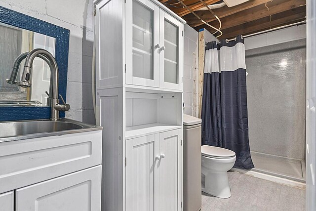 bathroom featuring vanity, a shower stall, and toilet