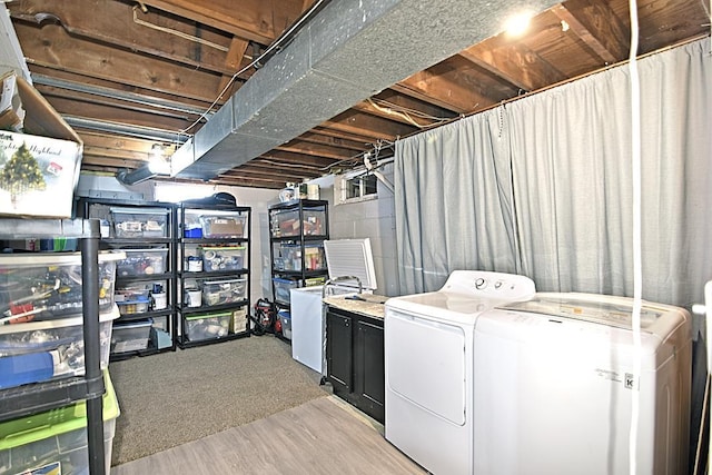 clothes washing area with laundry area, concrete block wall, and independent washer and dryer