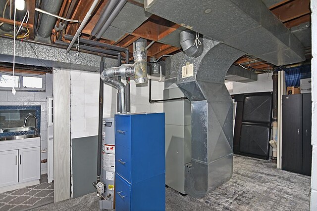 utility room with a sink and water heater