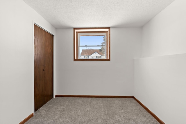 unfurnished bedroom with a closet, carpet flooring, and baseboards