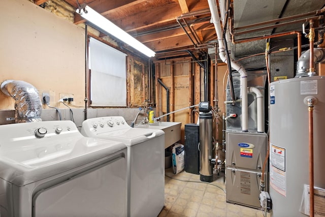 clothes washing area featuring tile patterned floors, washer and dryer, a sink, water heater, and laundry area