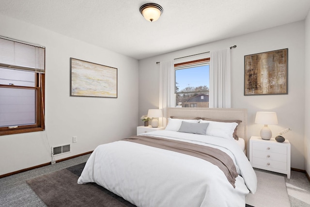 carpeted bedroom featuring visible vents and baseboards