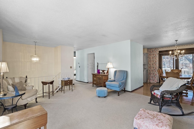 carpeted living area featuring a textured ceiling and an inviting chandelier