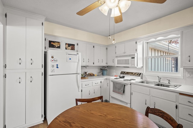 kitchen with ceiling fan, white appliances, a sink, white cabinetry, and light countertops