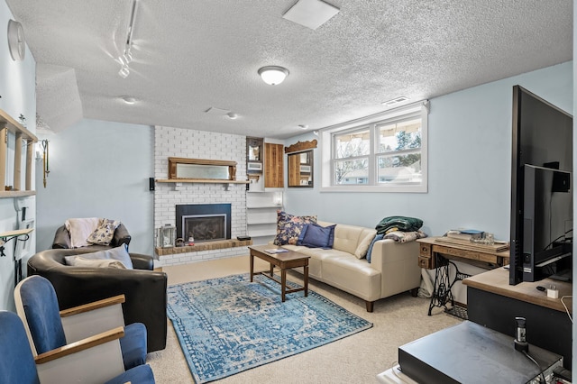 living area with a textured ceiling, carpet floors, and a brick fireplace