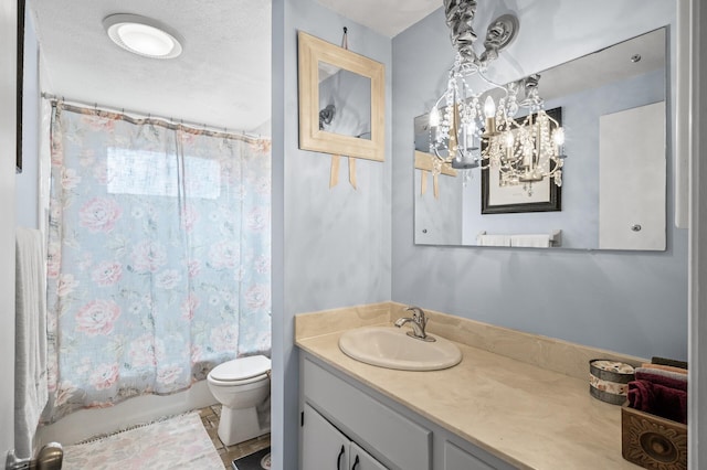 bathroom featuring shower / bath combo, vanity, toilet, and a textured ceiling