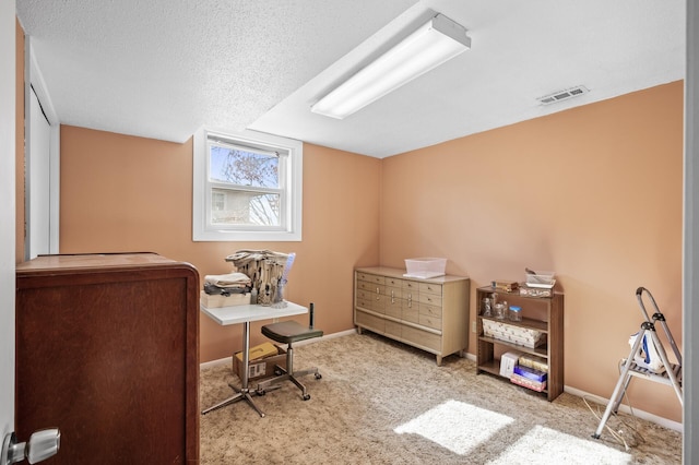 home office with baseboards, carpet, visible vents, and a textured ceiling