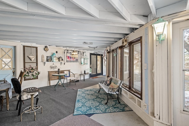 interior space featuring beam ceiling and plenty of natural light