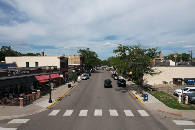 view of road featuring curbs, street lighting, and sidewalks