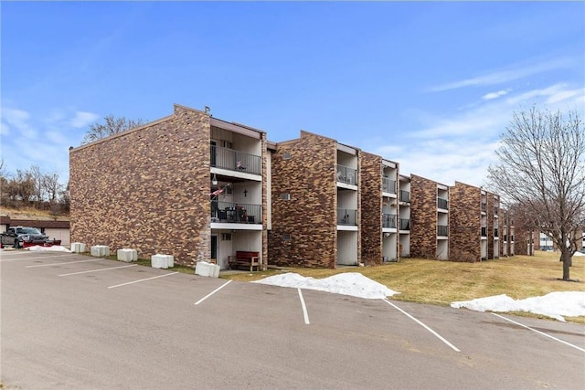 view of property featuring uncovered parking