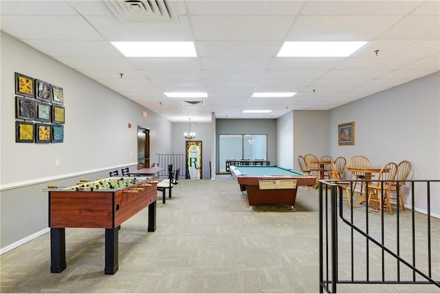 recreation room featuring baseboards, a paneled ceiling, visible vents, and light colored carpet