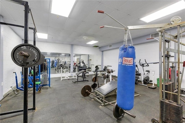 gym with a drop ceiling and visible vents