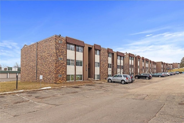 view of property featuring uncovered parking