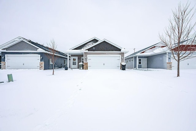 craftsman house featuring an attached garage and stone siding