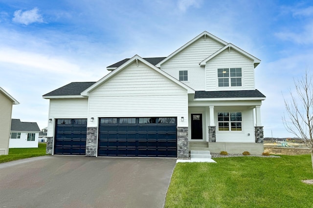 craftsman inspired home with a front yard, stone siding, driveway, and an attached garage