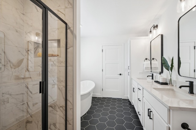 full bath featuring double vanity, a freestanding tub, a sink, and a shower stall