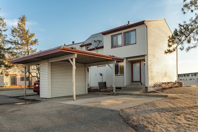 back of house with central AC and entry steps