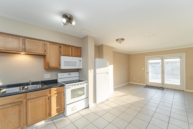 kitchen featuring white appliances, light tile patterned floors, baseboards, a sink, and dark countertops