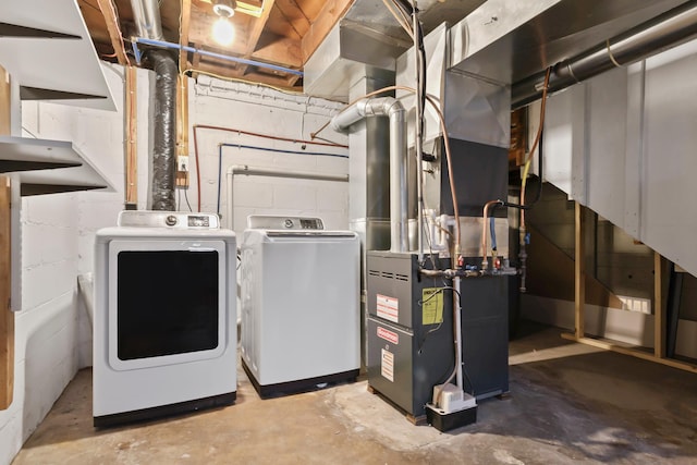 utilities featuring heating unit and washer and clothes dryer