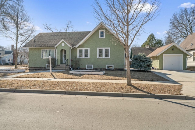 view of front of house featuring concrete driveway, roof with shingles, and stucco siding