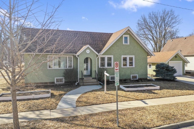 view of front of house featuring roof with shingles and stucco siding