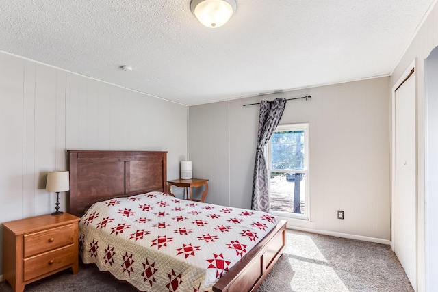 bedroom with a textured ceiling and carpet floors