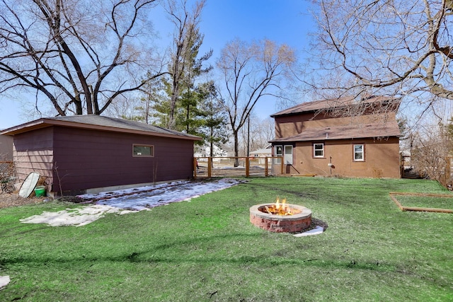 view of yard with a fire pit and fence